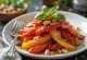 Salad paprika panggang disajikan dengan saus cuka balsamik dan kacang pinus sangrai.